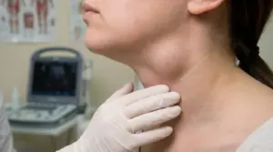 Persona con gonfiore visibile sul collo durante una visita medica di controllo